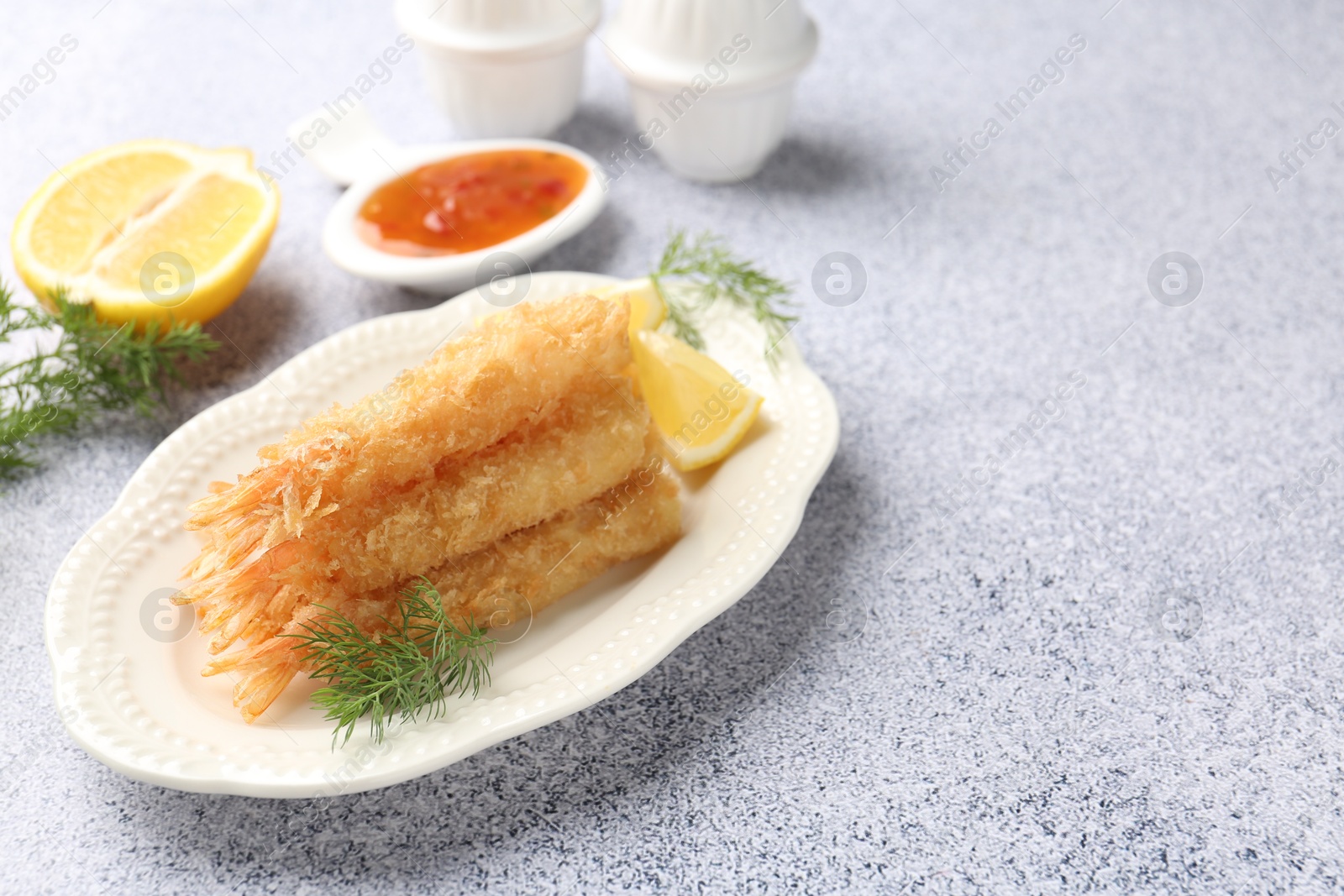 Tasty tempura shrimps, lemon and dill on grey textured table. Space for text Photo of Tasty tempura shrimps, lemon and dill on grey textured table. Space for text