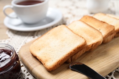 Photo of Slices of tasty toasted bread and jam on table, closeup