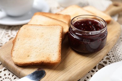 Photo of Slices of tasty toasted bread and jam on table, closeup