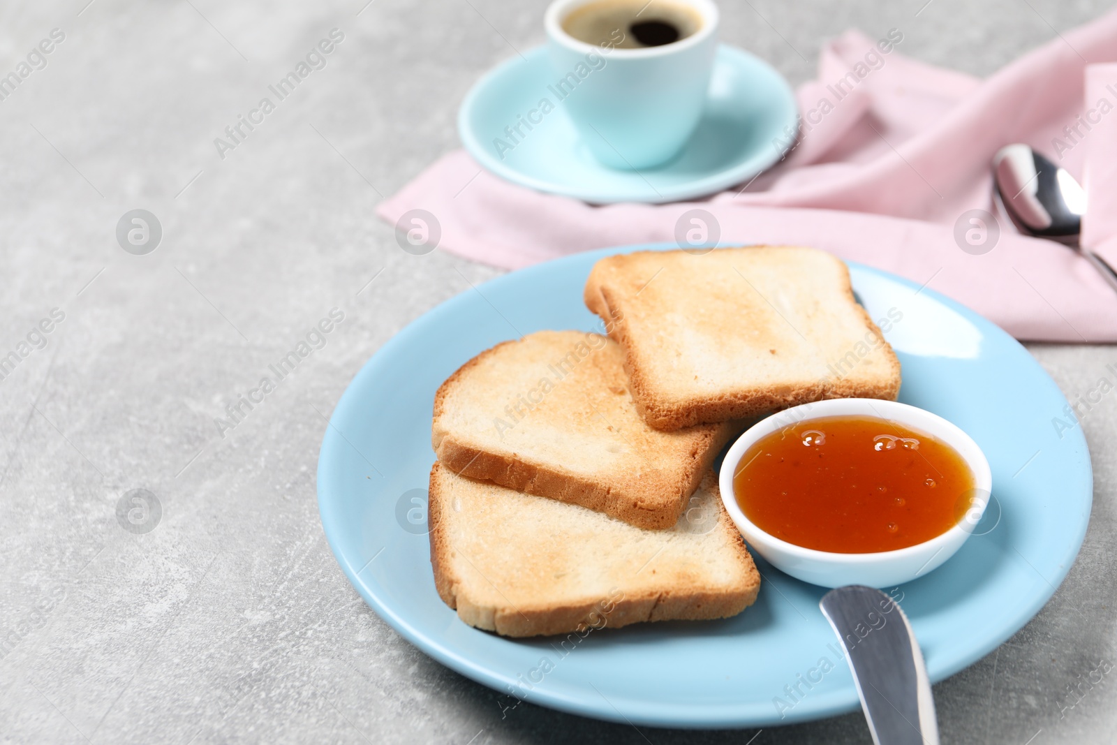 Slices of tasty toasted bread and jam on grey textured table, closeup. Space for text Photo of Slices of tasty toasted bread and jam on grey textured table, closeup. Space for text