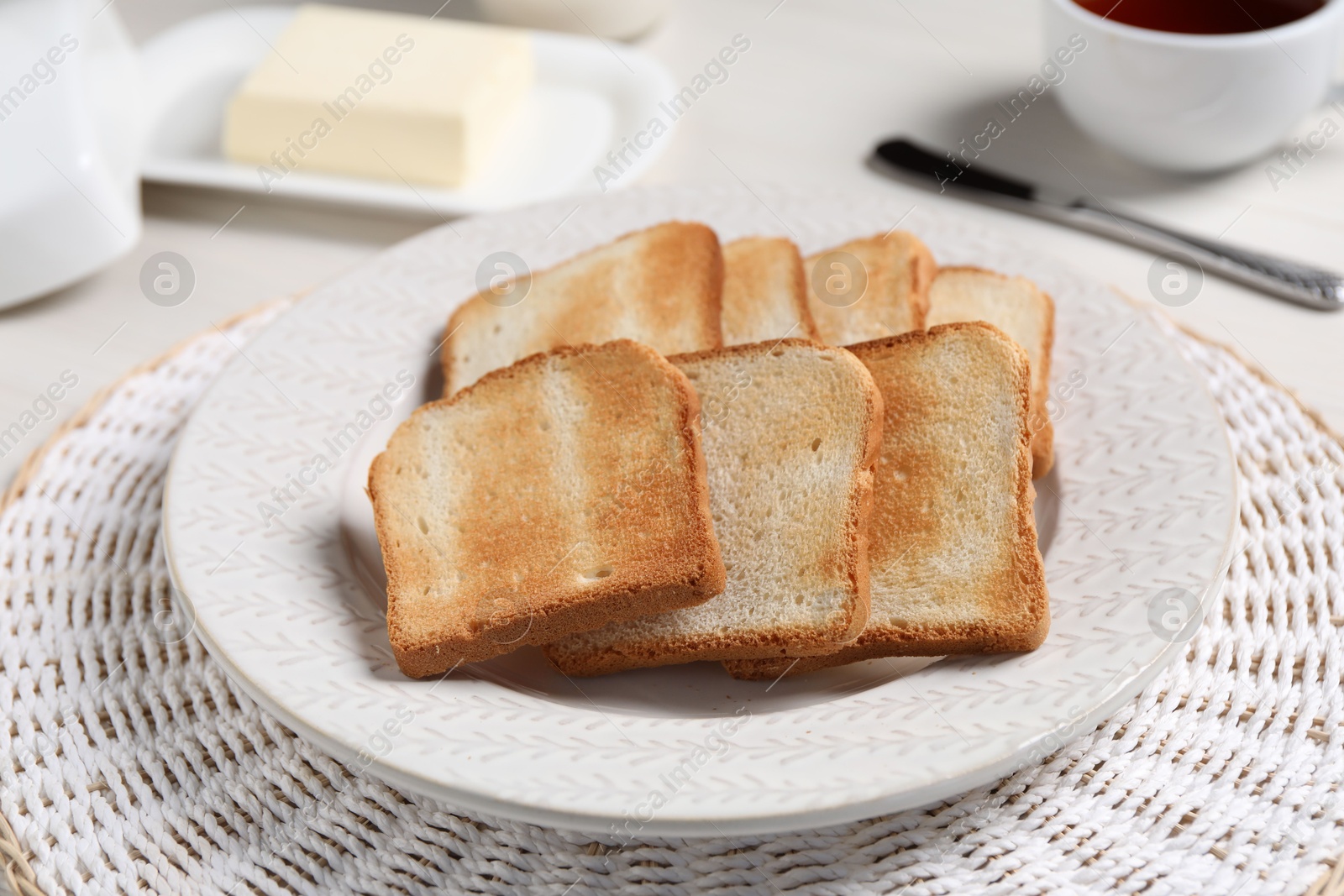 Slices of tasty toasted bread on white table, closeup Photo of Slices of tasty toasted bread on white table, closeup