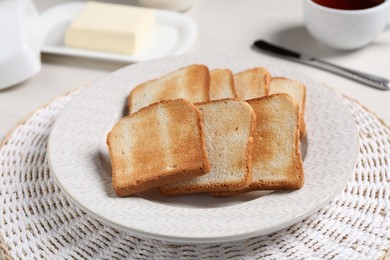 Photo of Slices of tasty toasted bread on white table, closeup