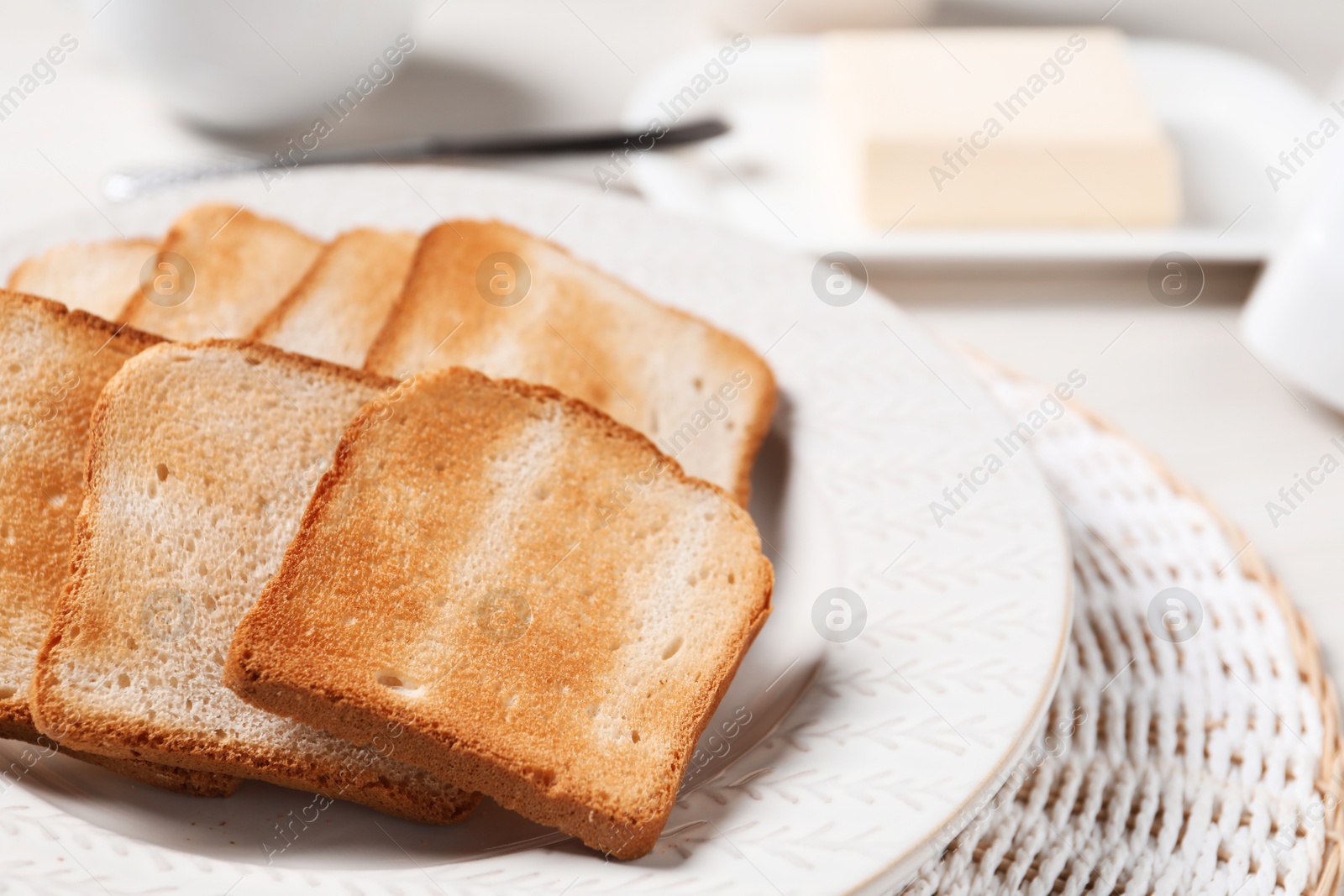 Slices of tasty toasted bread on white table, closeup Photo of Slices of tasty toasted bread on white table, closeup
