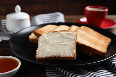 Photo of Slices of tasty toasted bread with butter and jam on table, closeup