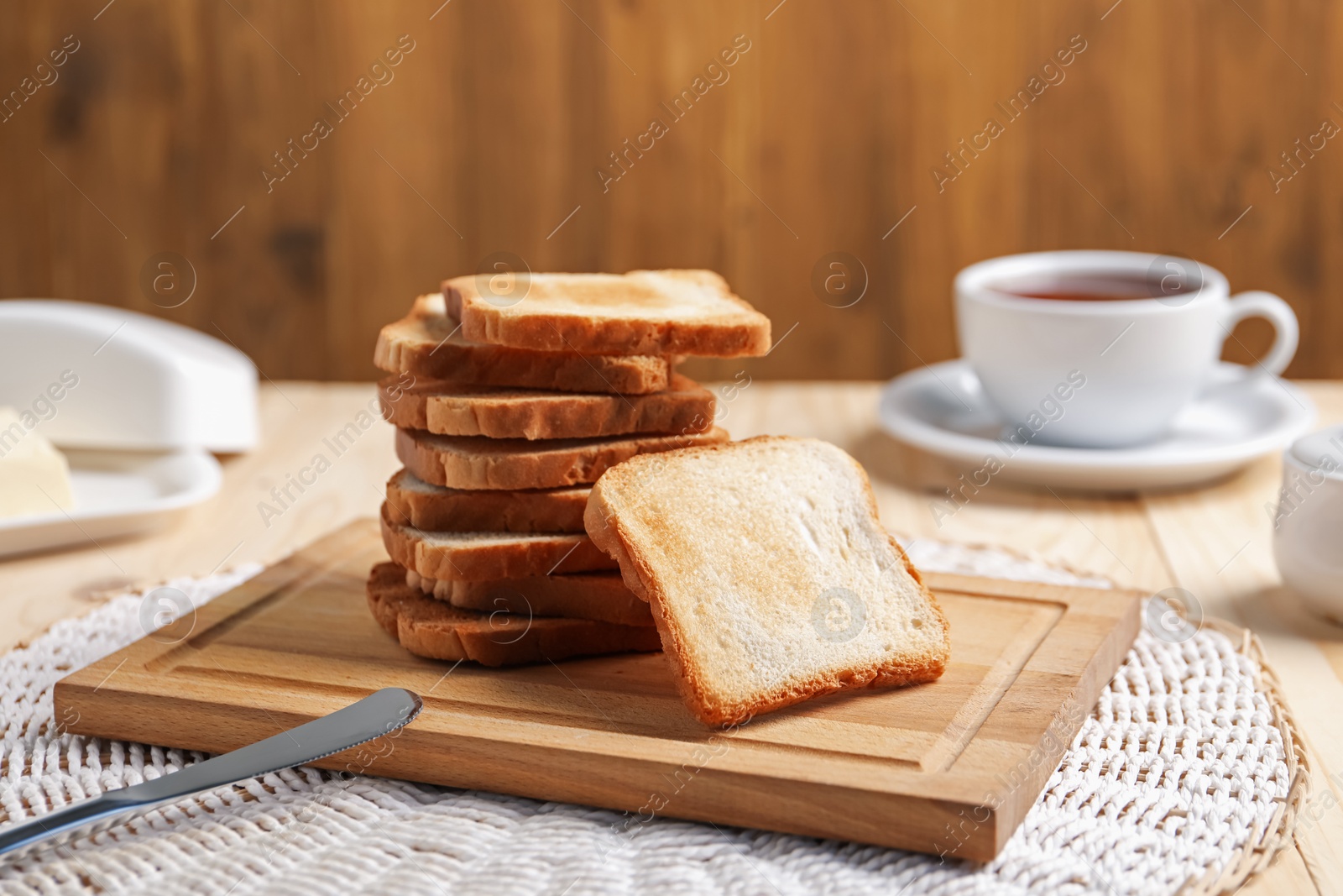 Slices of tasty toasted bread on wooden table, closeup Photo of Slices of tasty toasted bread on wooden table, closeup