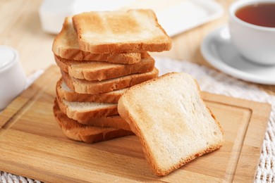 Photo of Slices of tasty toasted bread on table, closeup