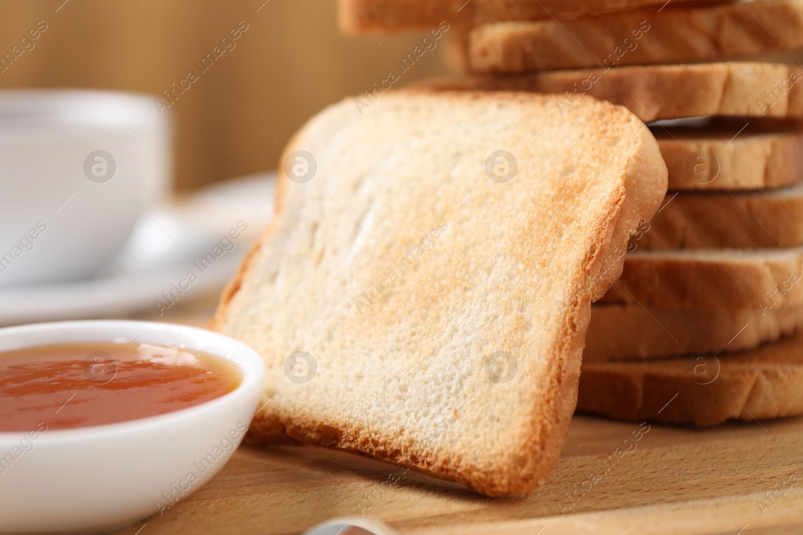 Slices of tasty toasted bread and jam on wooden table, closeup Photo of Slices of tasty toasted bread and jam on wooden table, closeup