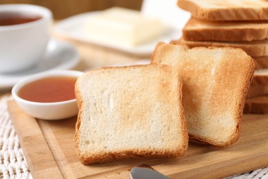Photo of Slices of tasty toasted bread and jam on table, closeup