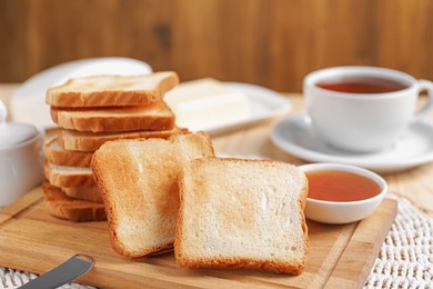 Photo of Slices of tasty toasted bread and jam on table, closeup