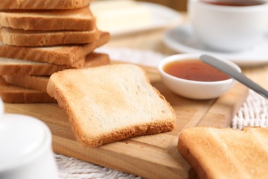Photo of Slices of tasty toasted bread and jam on table, closeup