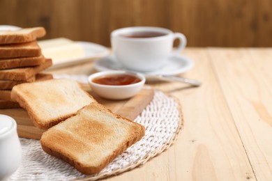 Photo of Slices of tasty toasted bread and jam on wooden table, closeup. Space for text