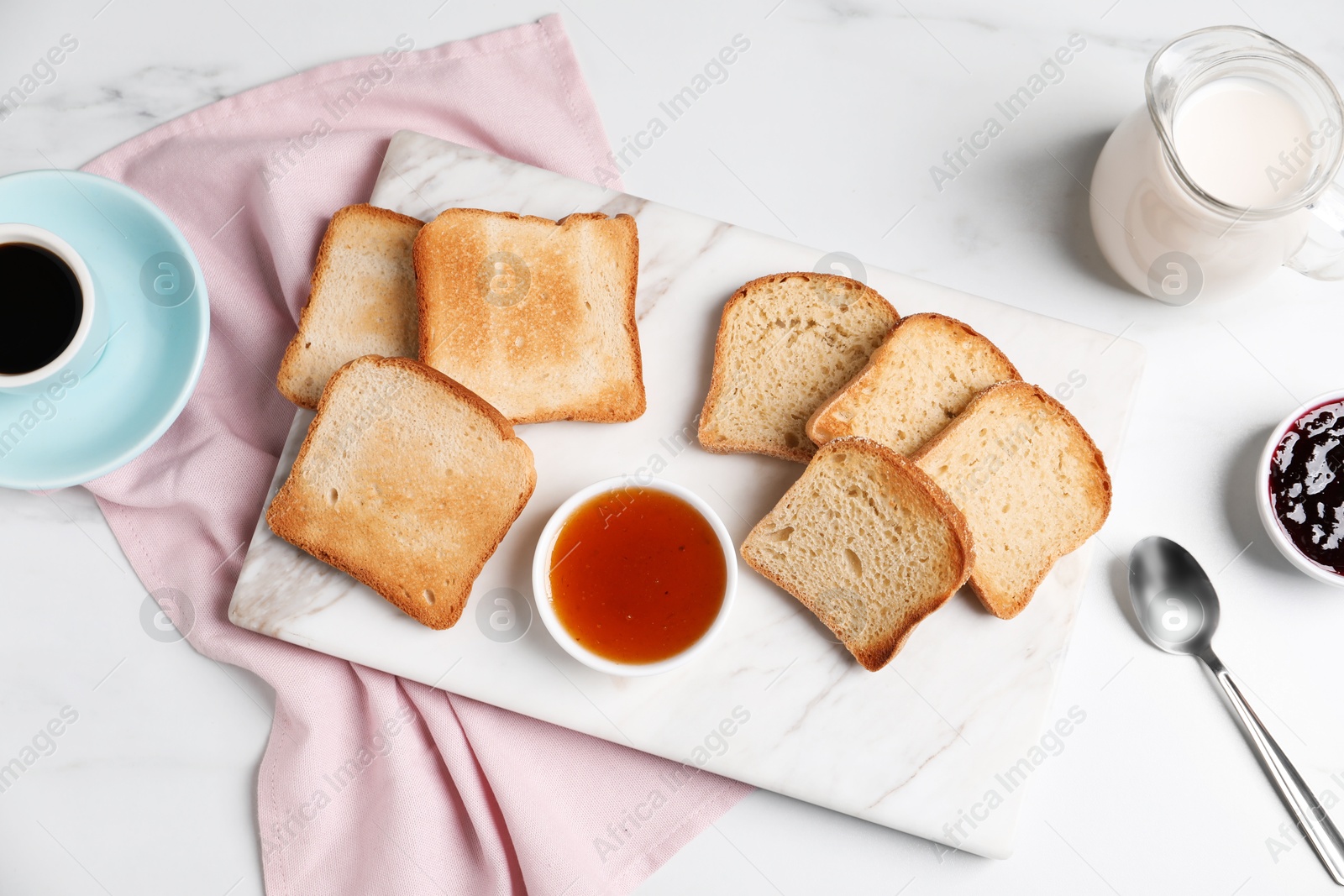 Slices of tasty toasted bread and jam on white marble table, flat lay Photo of Slices of tasty toasted bread and jam on white marble table, flat lay