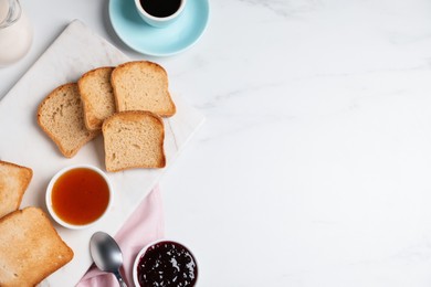 Photo of Slices of tasty toasted bread and jam on white marble table, flat lay. Space for text
