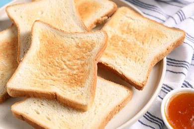 Photo of Slices of tasty toasted bread and jam on table, closeup