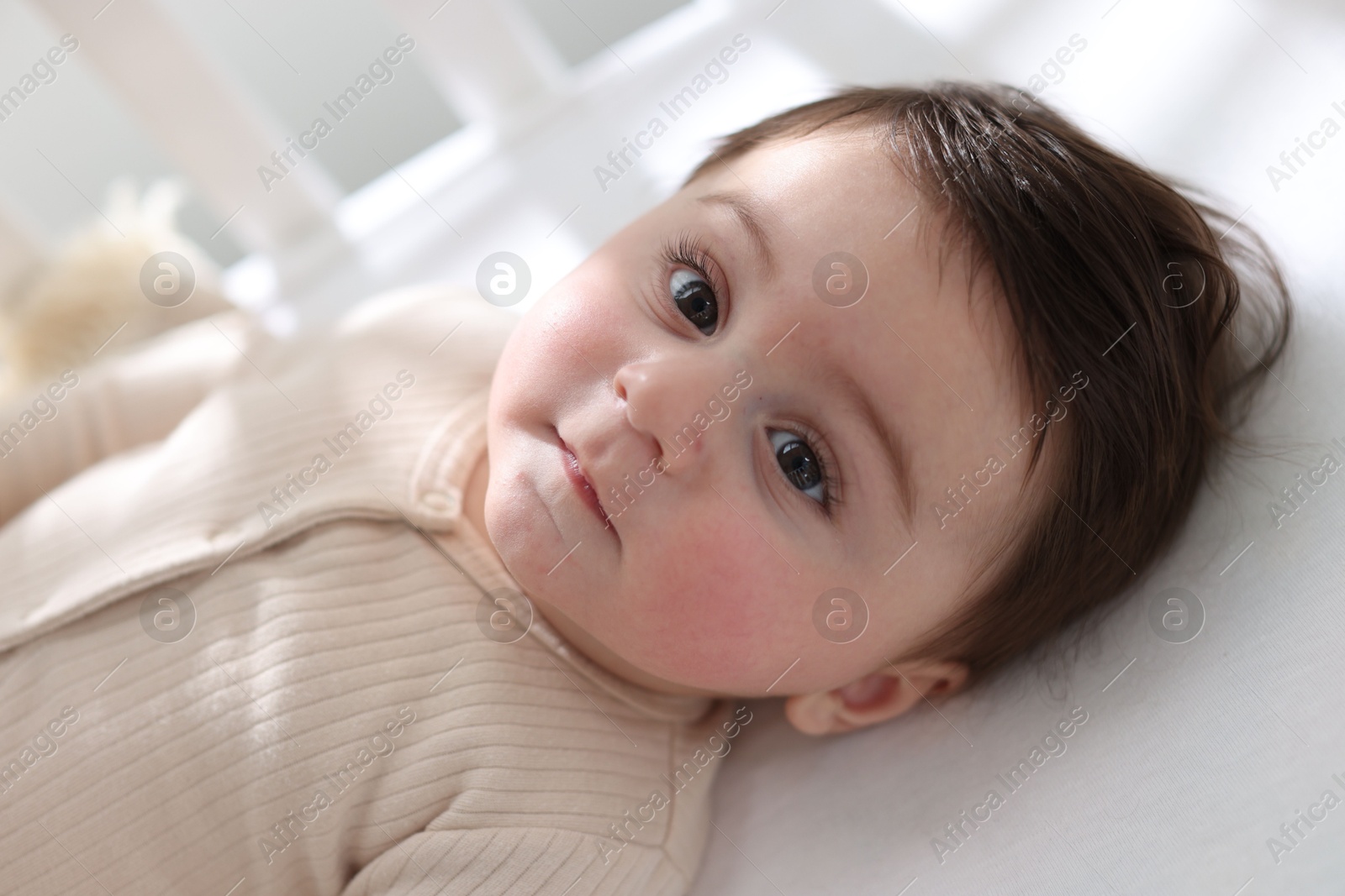 Bedtime. Cute little baby in crib at home Photo of Bedtime. Cute little baby in crib at home