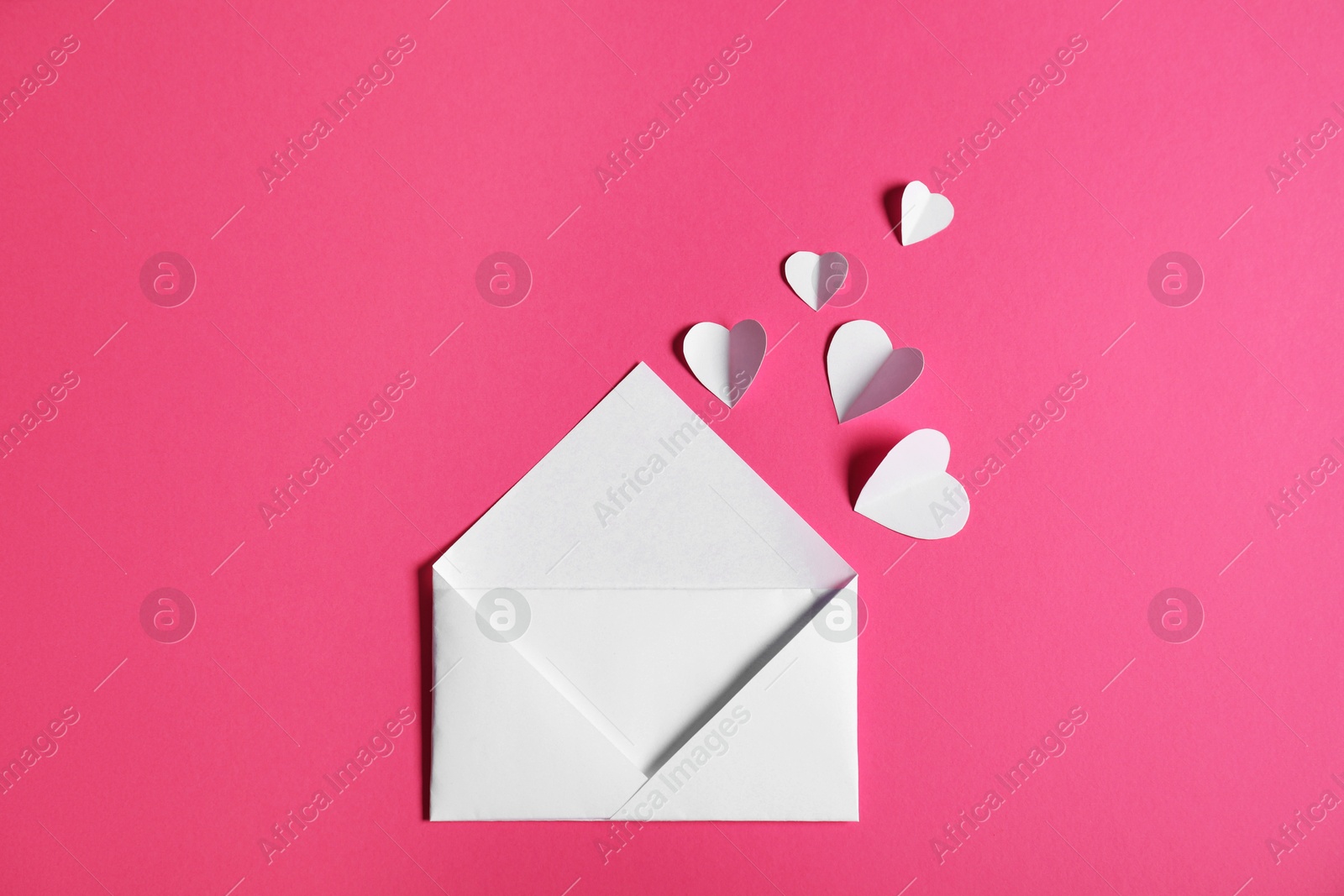 Many paper hearts flying out of envelope on pink background, flat lay Photo of Many paper hearts flying out of envelope on pink background, flat lay