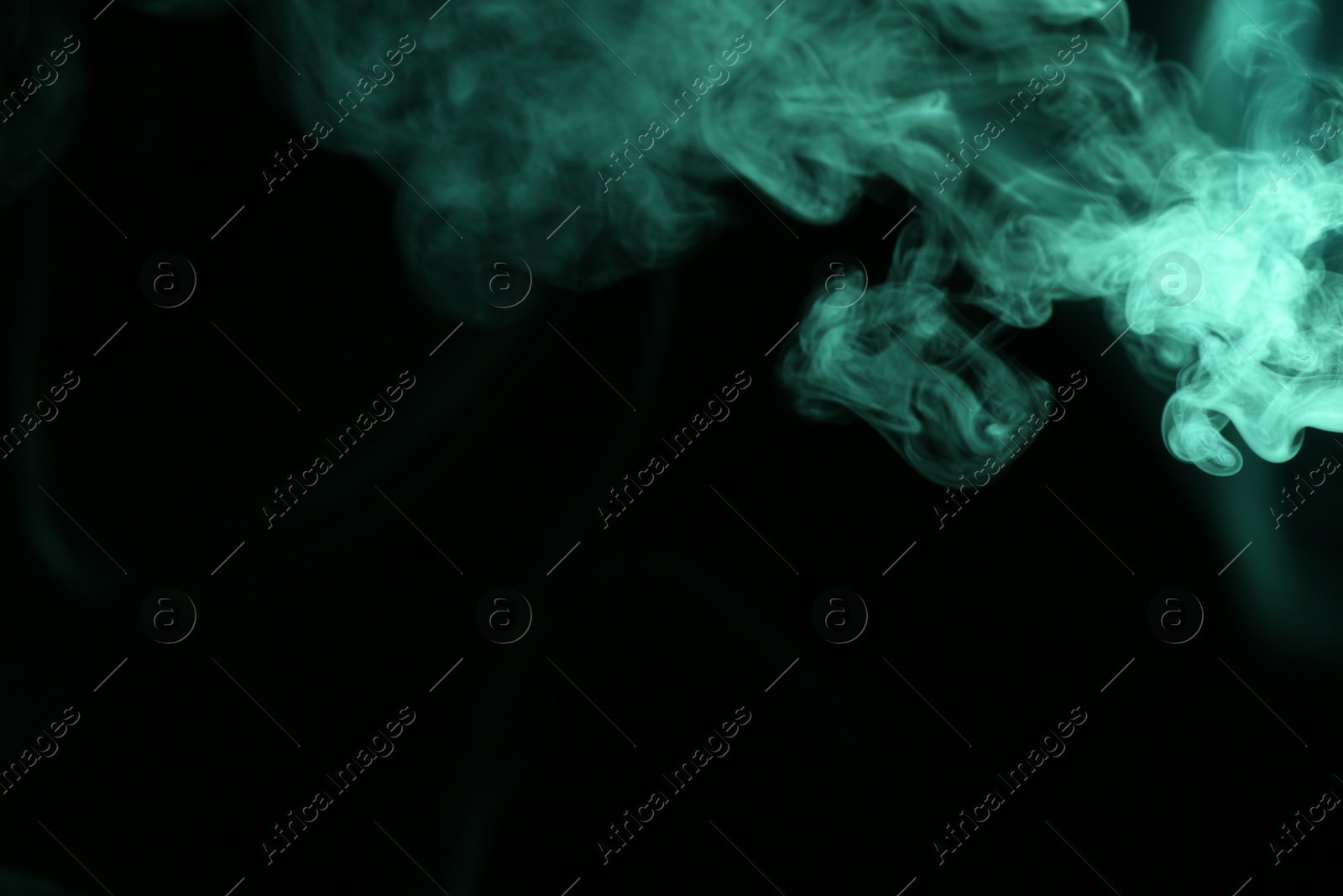 Beautiful smoke in green light on dark background, space for text Photo of Beautiful smoke in green light on dark background, space for text