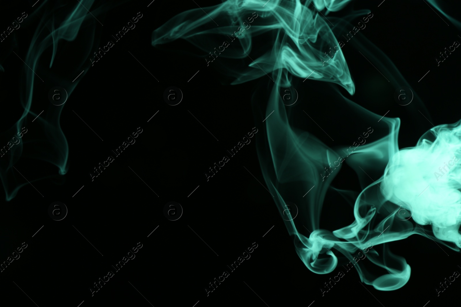 Beautiful smoke in green light on dark background, space for text Photo of Beautiful smoke in green light on dark background, space for text