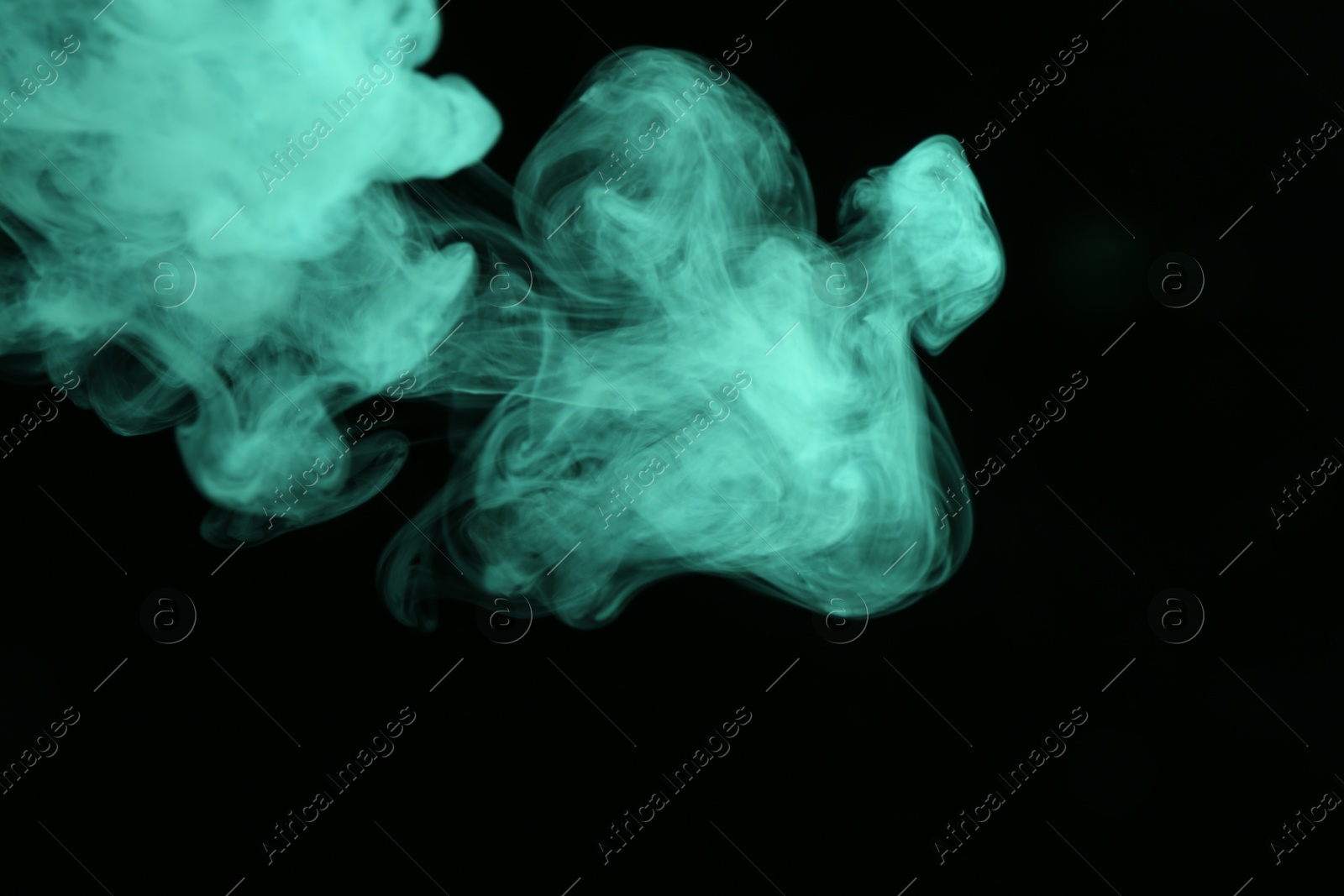Beautiful smoke in green light on dark background Photo of Beautiful smoke in green light on dark background