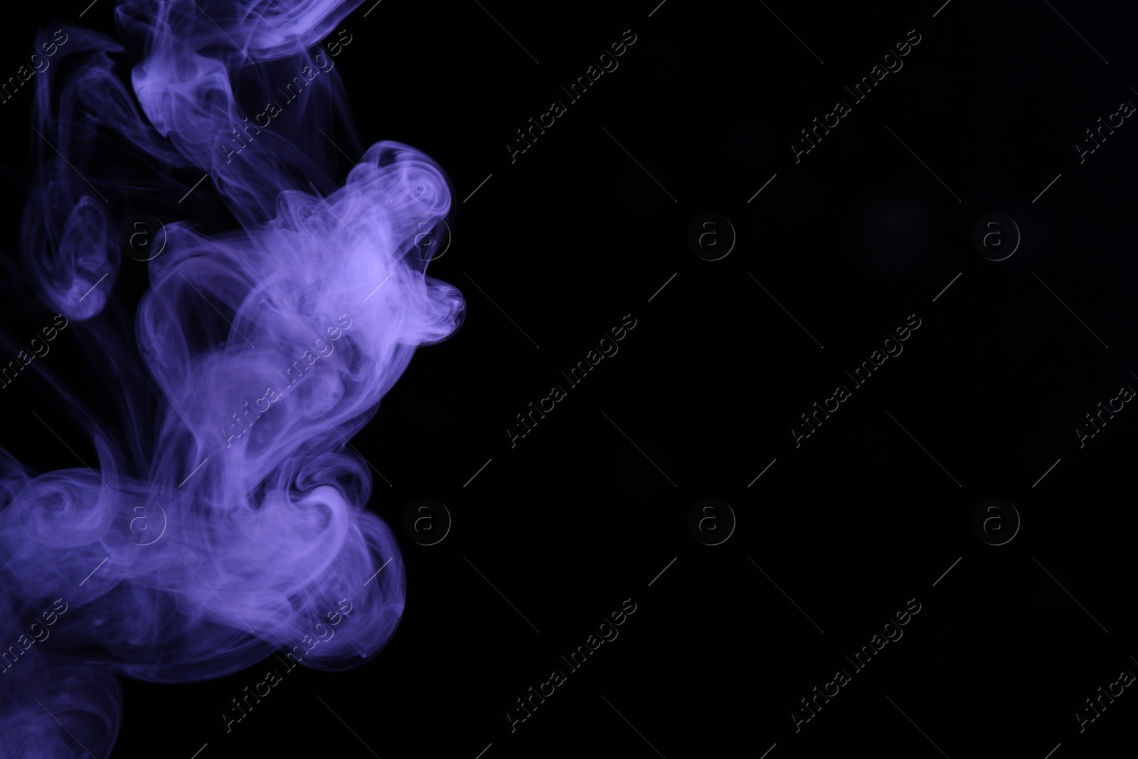 Beautiful smoke in purple light on dark background, space for text Photo of Beautiful smoke in purple light on dark background, space for text