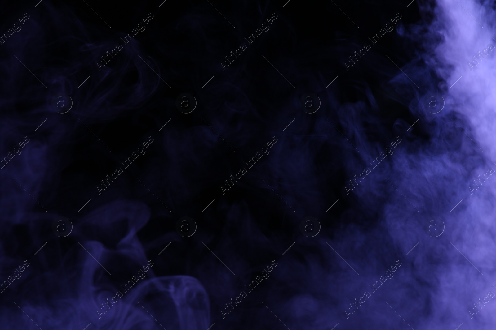 Beautiful smoke in purple light on dark background, space for text Photo of Beautiful smoke in purple light on dark background, space for text