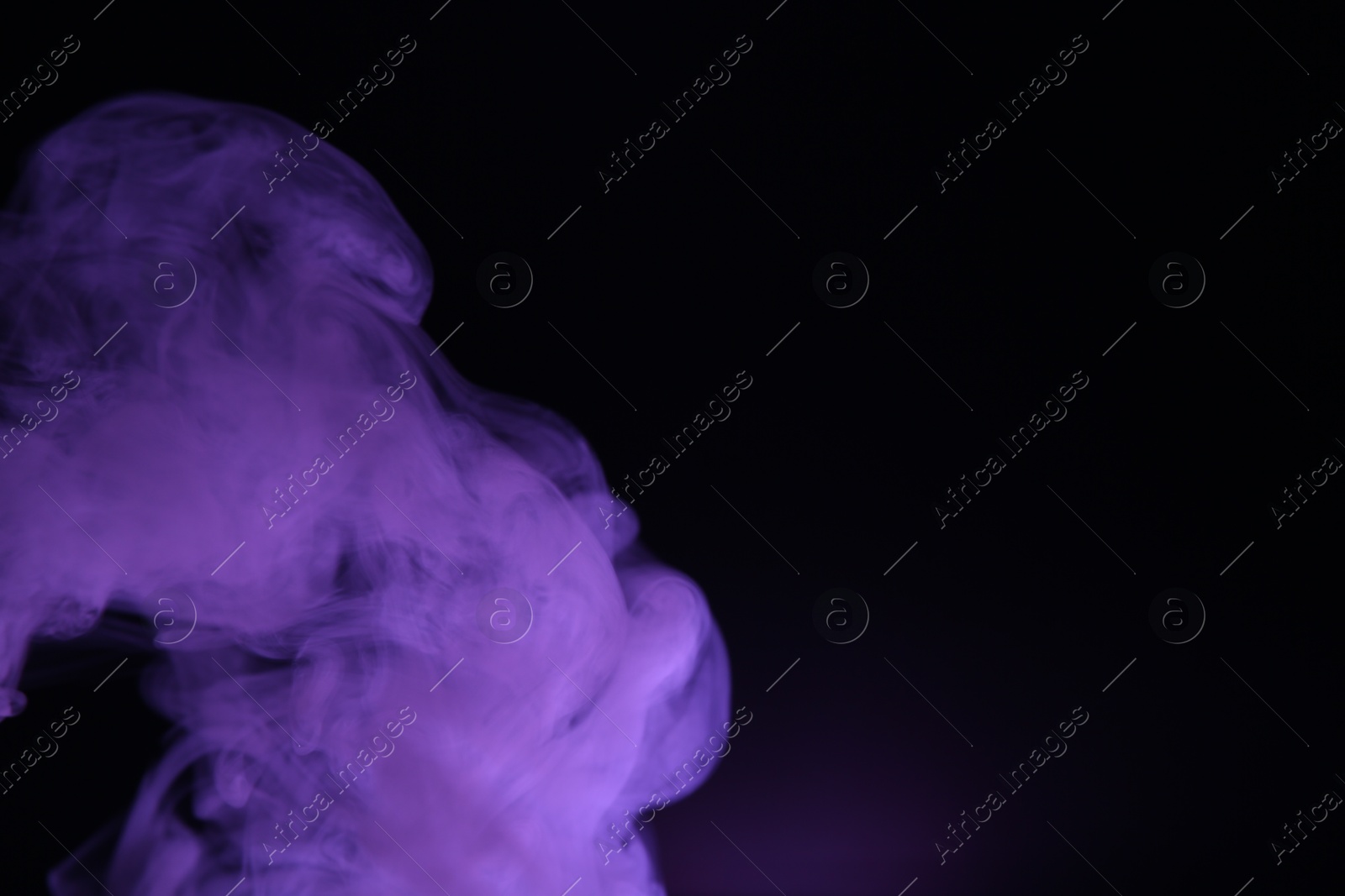 Beautiful smoke in purple light on dark background, space for text Photo of Beautiful smoke in purple light on dark background, space for text