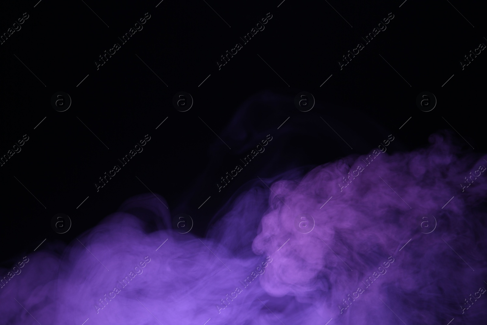 Beautiful smoke in purple light on dark background, space for text Photo of Beautiful smoke in purple light on dark background, space for text