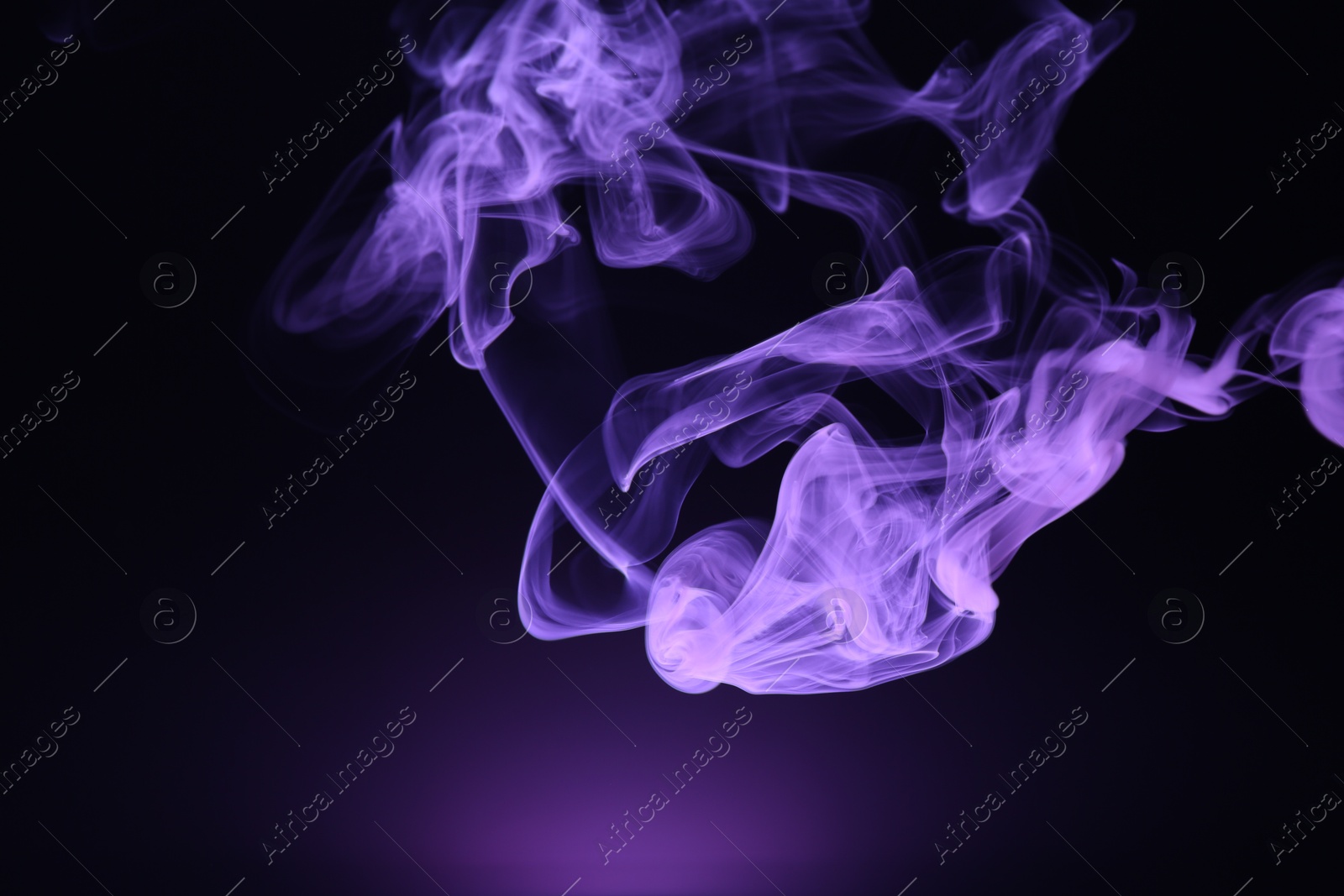 Beautiful smoke in purple light on dark background, space for text Photo of Beautiful smoke in purple light on dark background, space for text