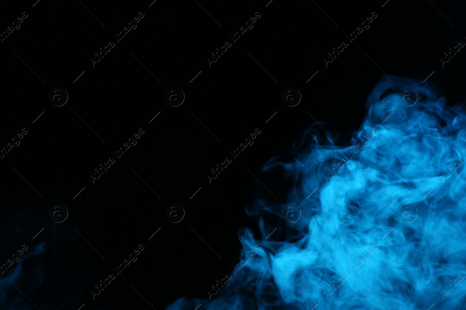 Beautiful smoke in blue light on dark background, space for text Photo of Beautiful smoke in blue light on dark background, space for text