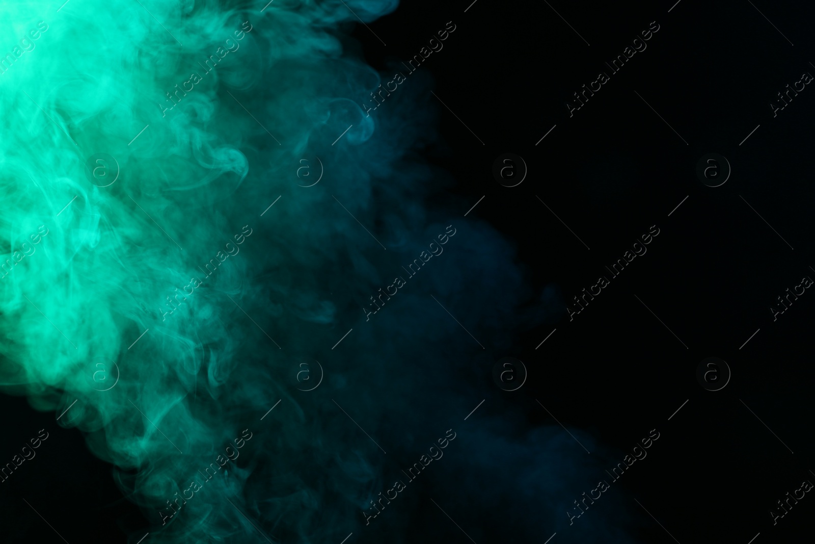 Photo of Beautiful smoke in neon lights on dark background, space for text