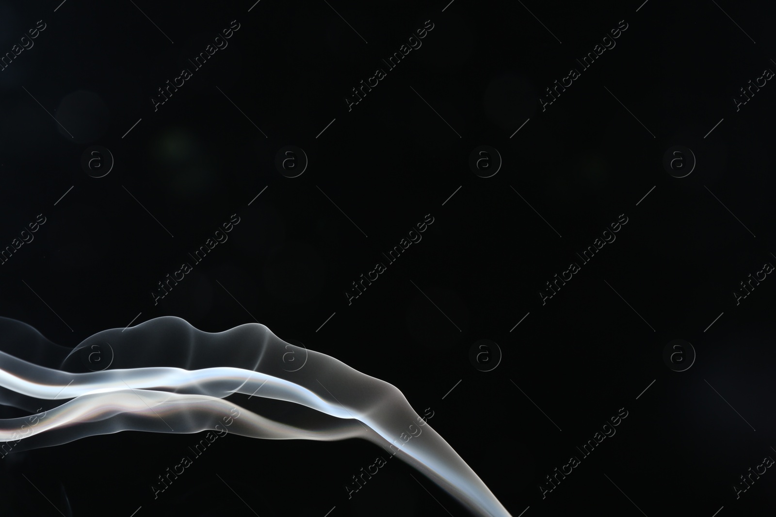 Beautiful smoke in lights on dark background, space for text Photo of Beautiful smoke in lights on dark background, space for text