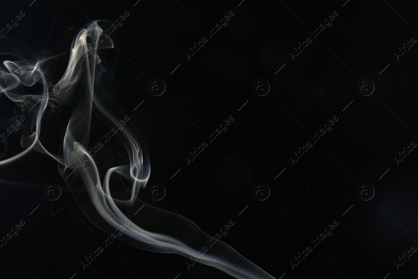 Beautiful smoke in lights on dark background, space for text Photo of Beautiful smoke in lights on dark background, space for text