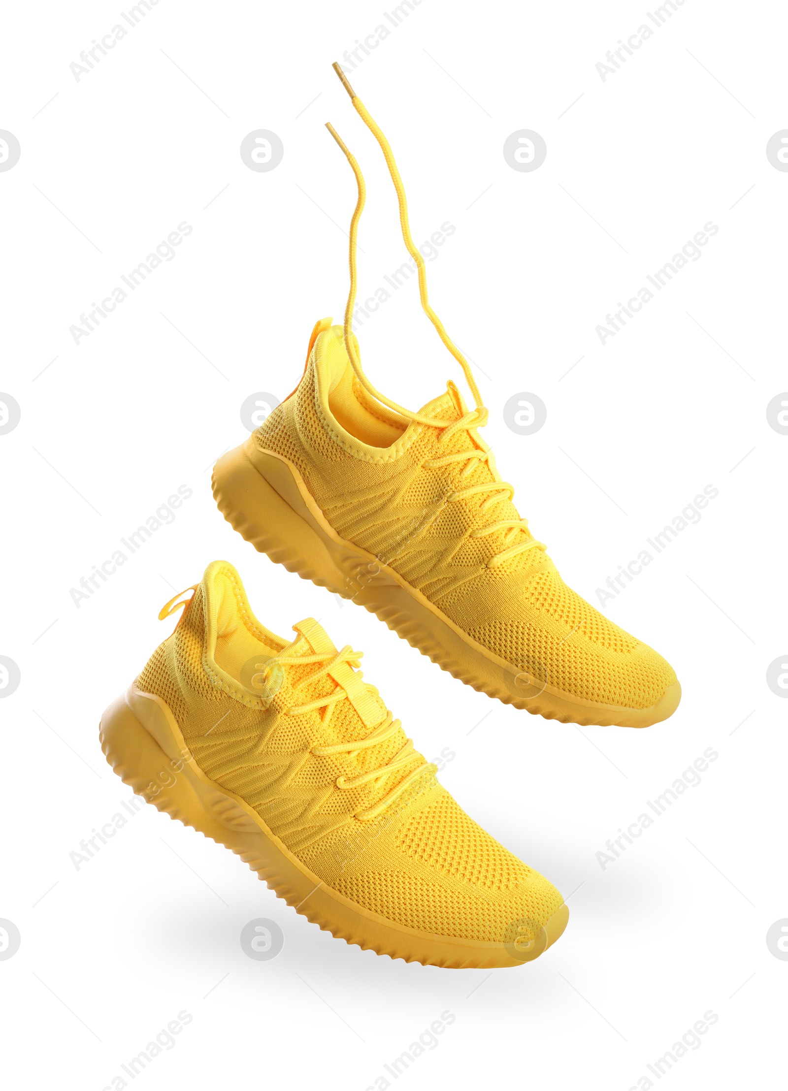 Stylish yellow sneakers in air on white background Image of Stylish yellow sneakers in air on white background