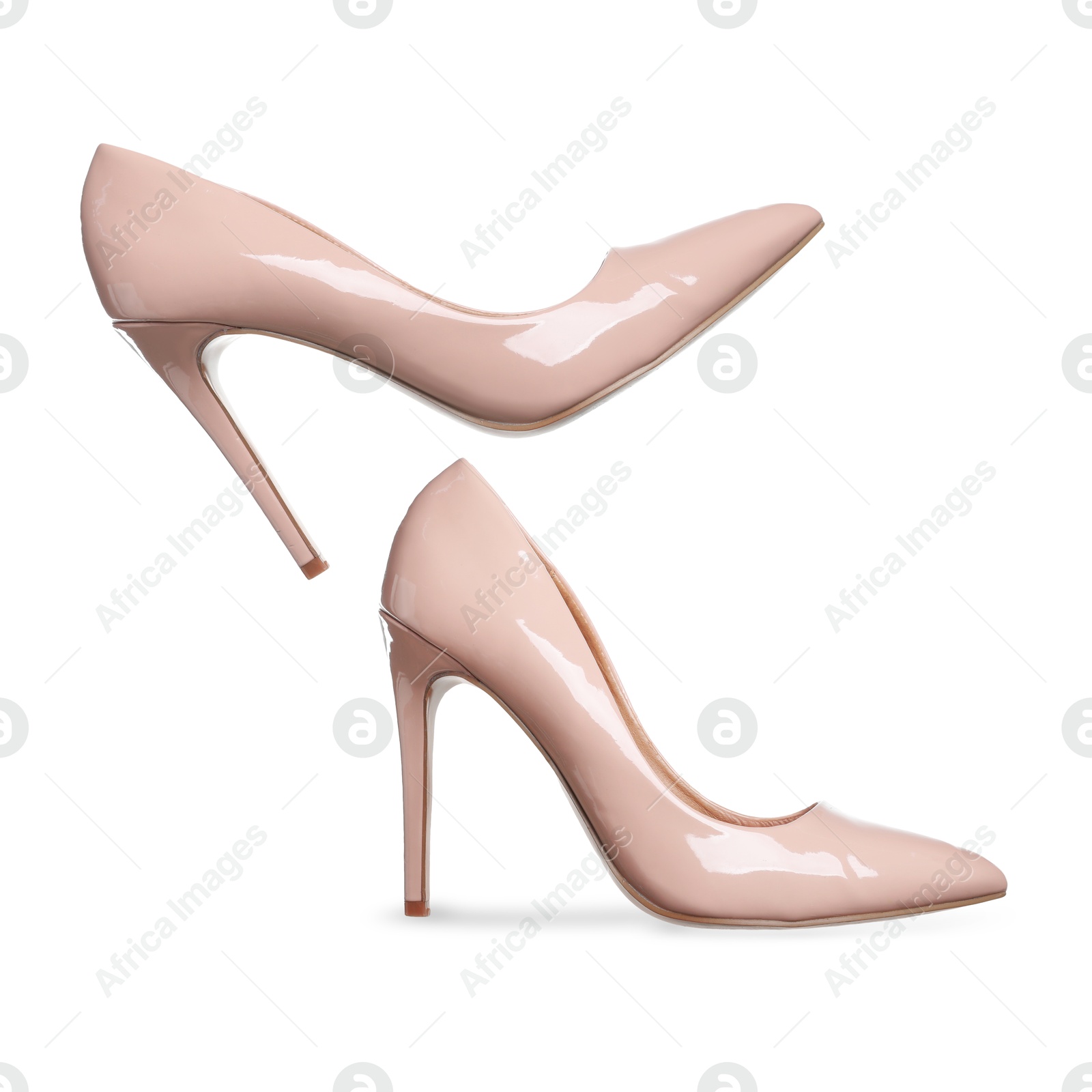 Stylish beige high heel shoes in air on white background Image of Stylish beige high heel shoes in air on white background