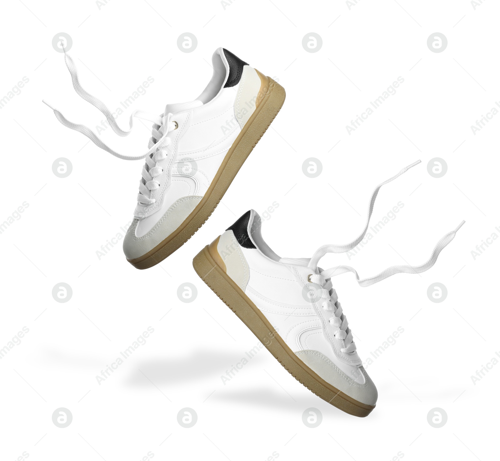 Image of Stylish sneakers in air on white background