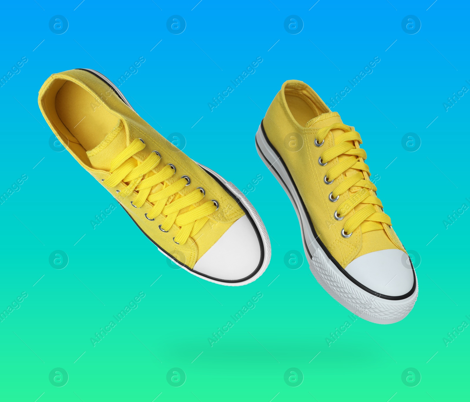 Stylish yellow sneakers in air on blue green gradient background Image of Stylish yellow sneakers in air on blue green gradient background