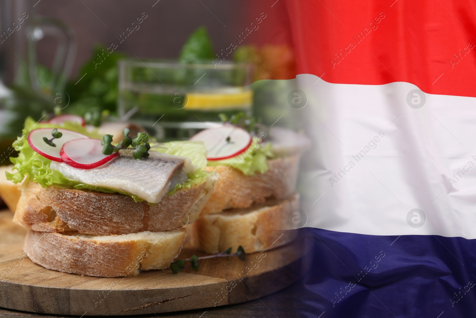 Tasty sandwiches with herring on wooden table and flag of Netherlands Image of Tasty sandwiches with herring on wooden table and flag of Netherlands