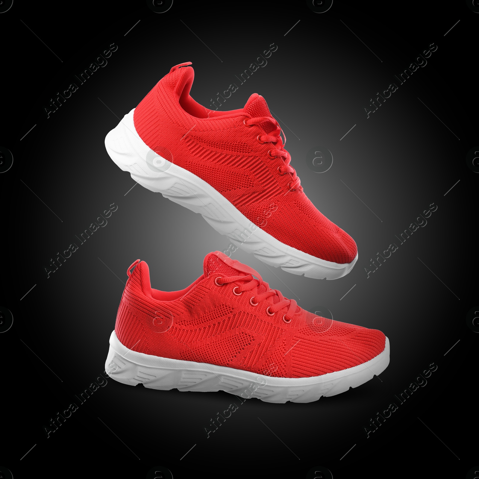 Stylish red sneakers in air on back gradient background Image of Stylish red sneakers in air on back gradient background
