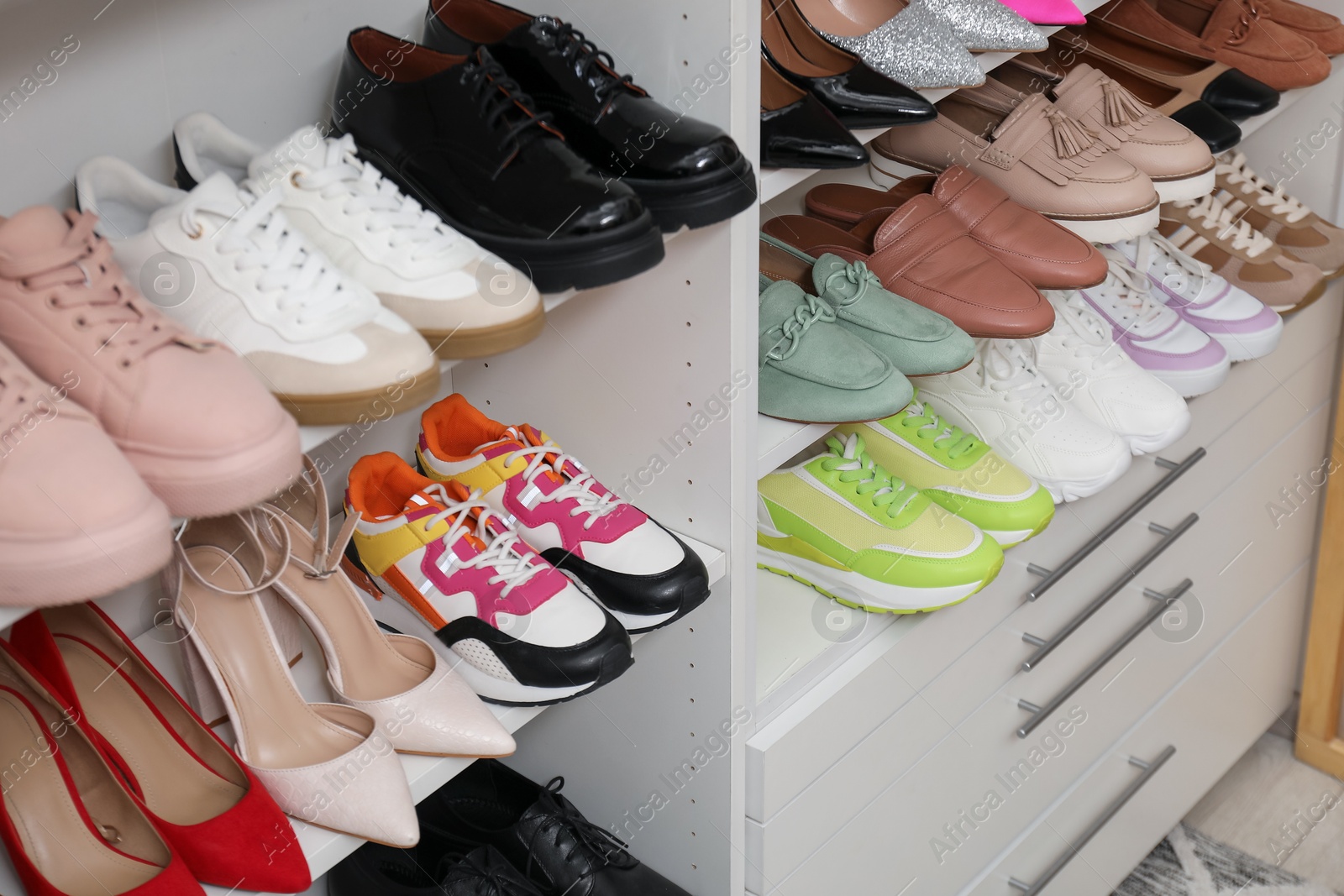 Shoe storage. Shelving unit with many different pairs of footwear indoors, closeup Photo of Shoe storage. Shelving unit with many different pairs of footwear indoors, closeup