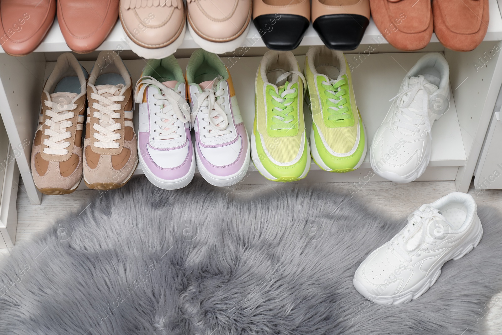 Shoe storage. Shelving unit with many different pairs of footwear indoors, closeup Photo of Shoe storage. Shelving unit with many different pairs of footwear indoors, closeup