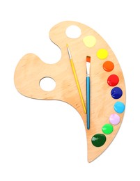 Photo of Wooden palette with paints and brushes isolated on white, top view