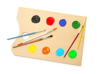 Photo of Wooden palette with paints and brushes isolated on white, top view