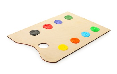 Photo of Wooden palette with paints isolated on white