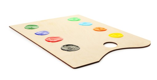 Photo of Wooden palette with paints isolated on white