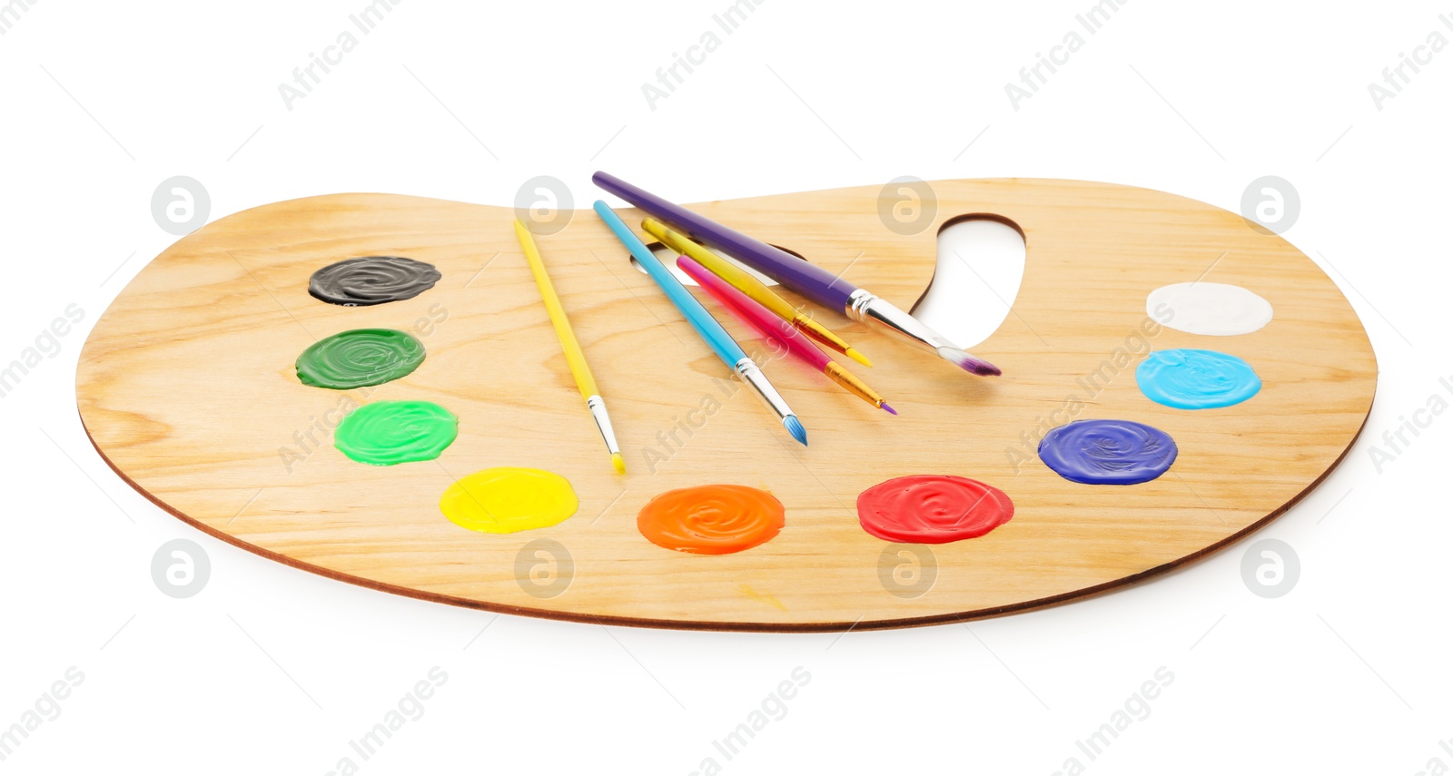 Photo of Wooden palette with paints and brushes isolated on white