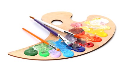 Photo of Wooden palette with paints and brushes isolated on white