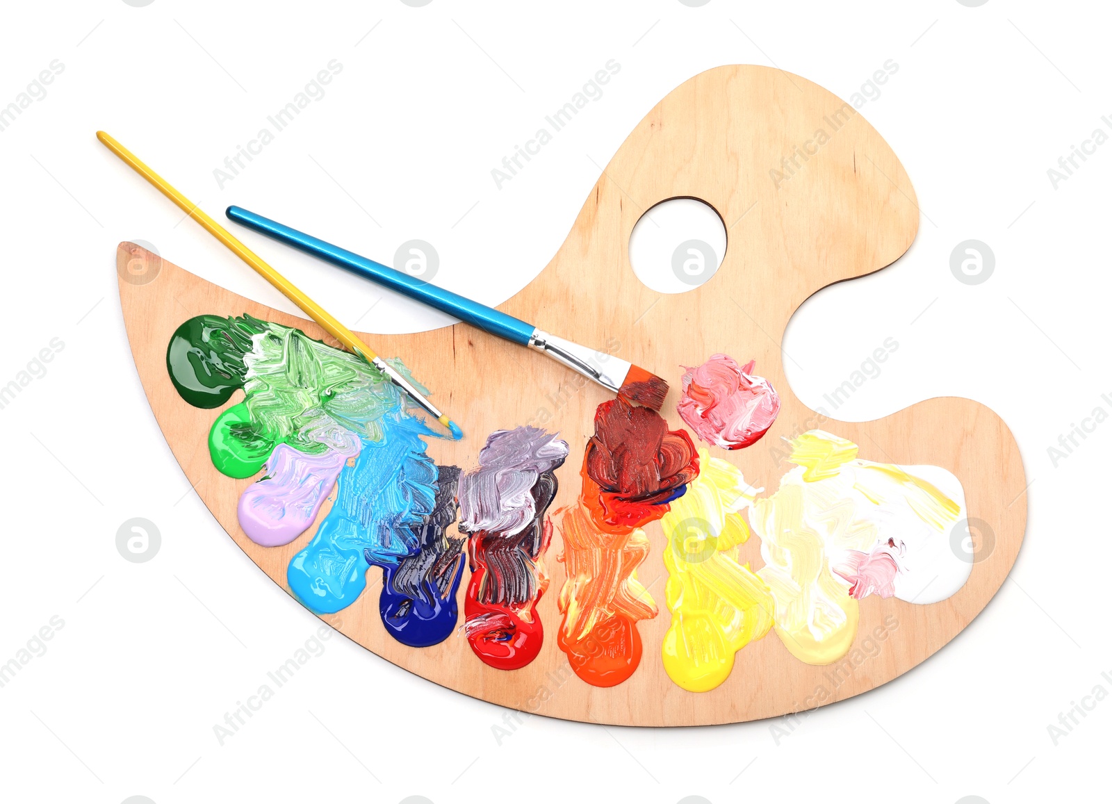 Wooden palette with paints and brushes isolated on white, top view Photo of Wooden palette with paints and brushes isolated on white, top view