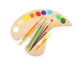 Photo of Wooden palette with paints and brushes isolated on white, top view