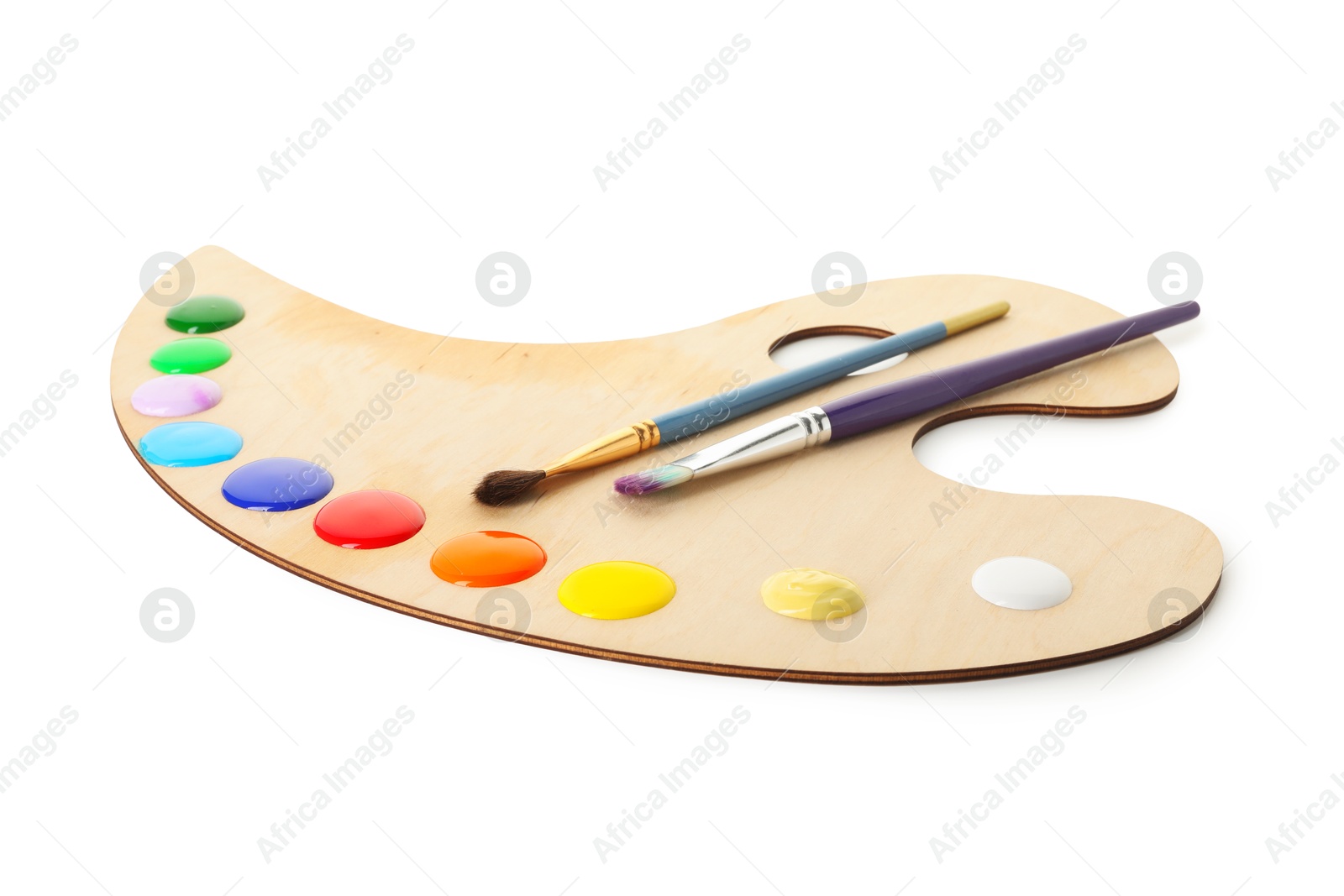 Wooden palette with paints and brushes isolated on white Photo of Wooden palette with paints and brushes isolated on white