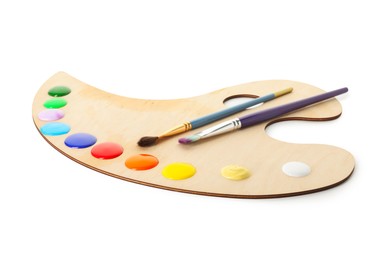 Photo of Wooden palette with paints and brushes isolated on white